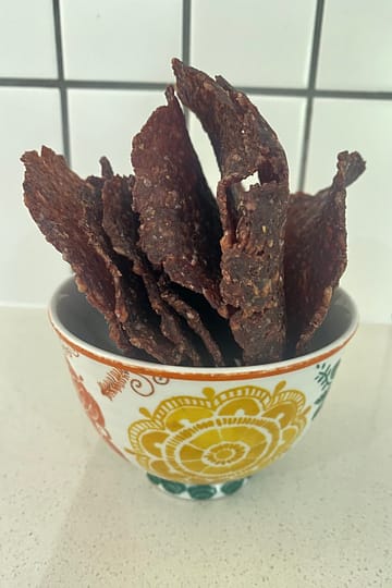 Homemade dried beef pieces ready for a hiking trail snack