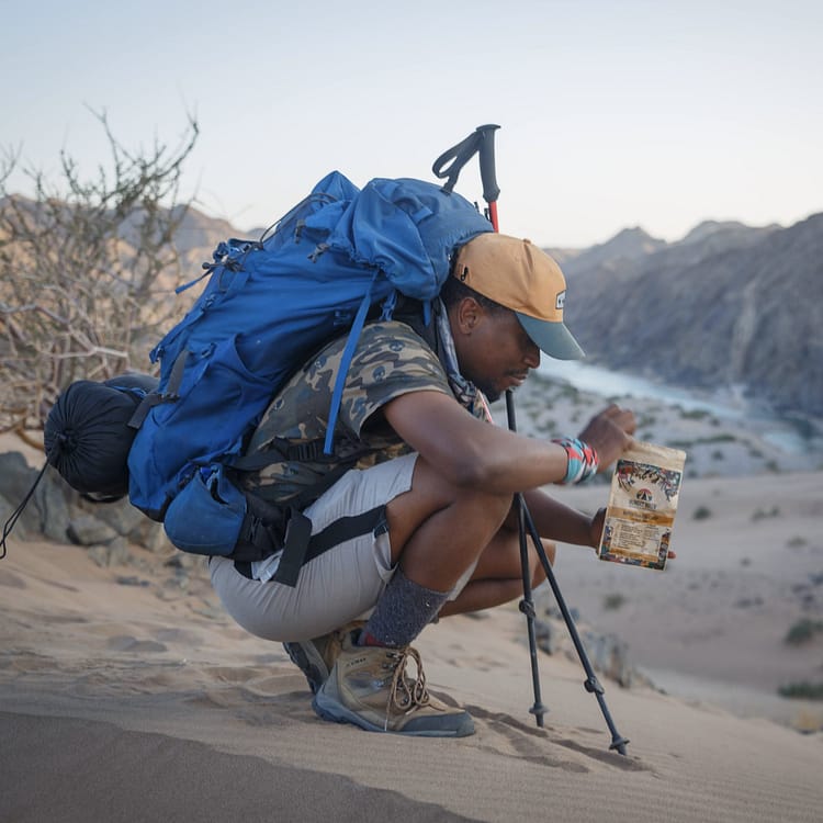 Hiker preparing a Hungry Hiker dehydrated meal during a multi-day hike in the Fish River Canyon