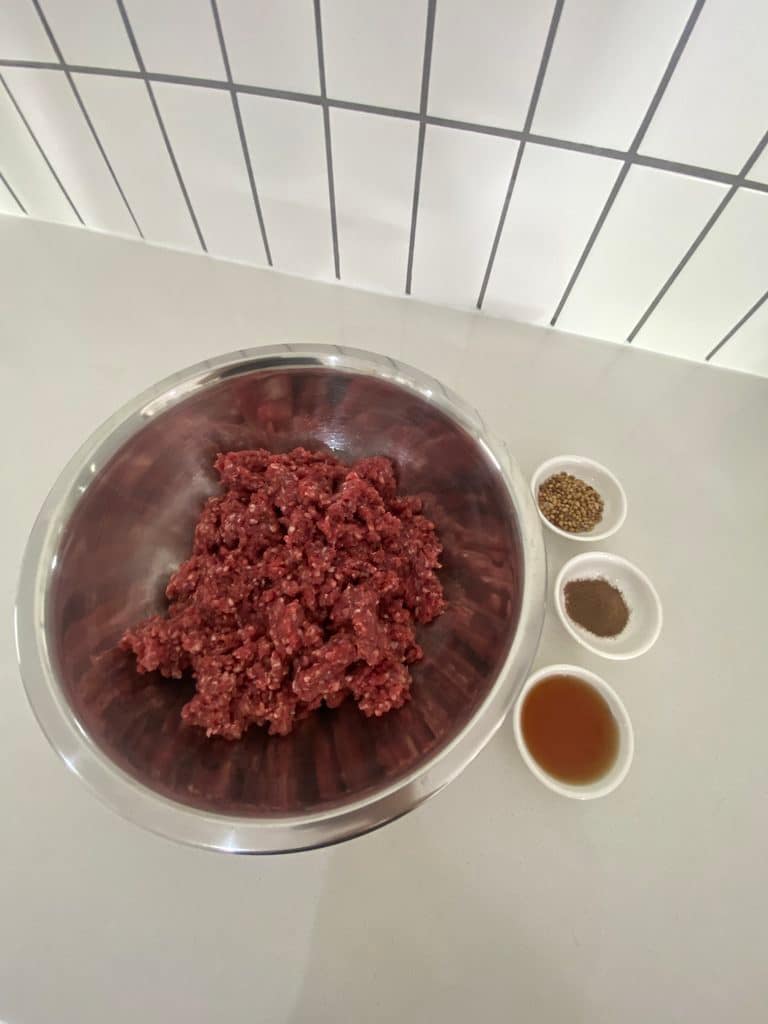 Ingredients for homemade high-protein trail snack with ground beef and spices
