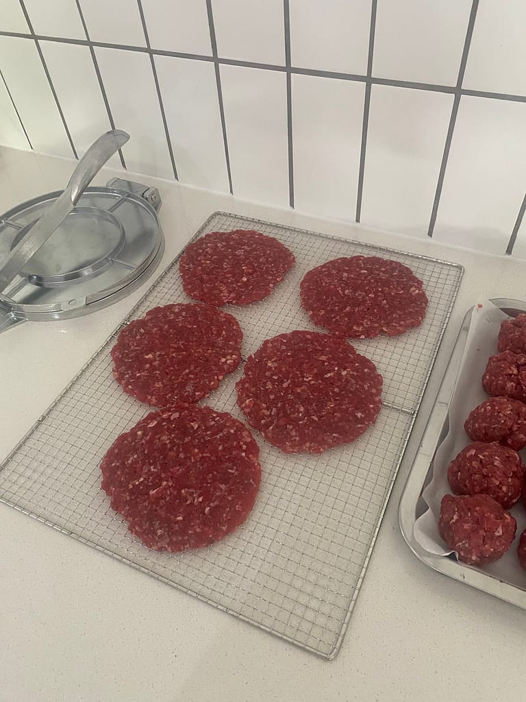 Thin seasoned beef patties ready for dehydrating